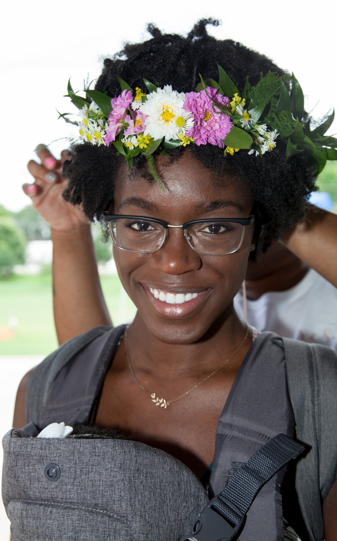 Receiving a crown of white and purple flowers
