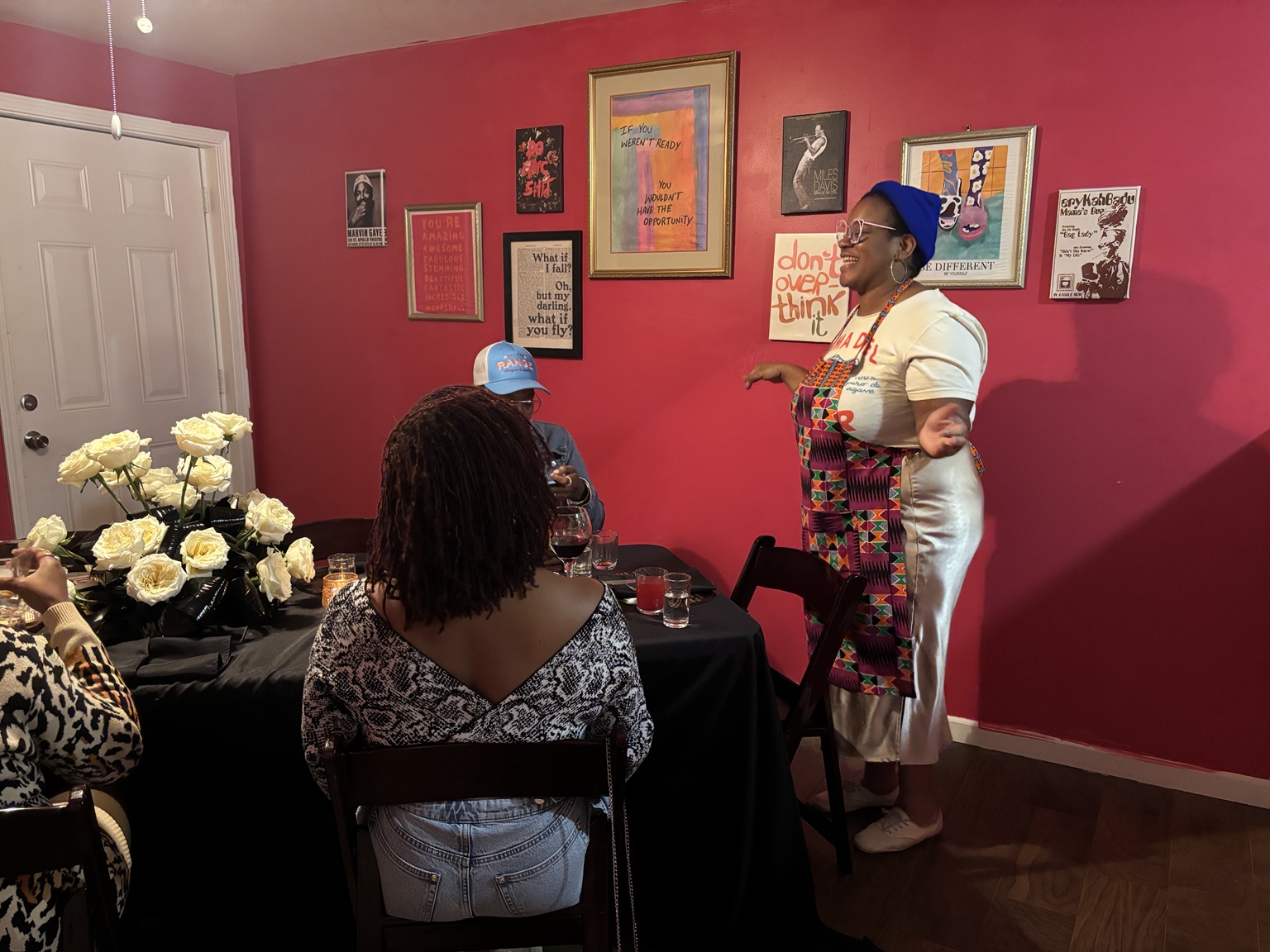 Ronisha welcoming guests to the table