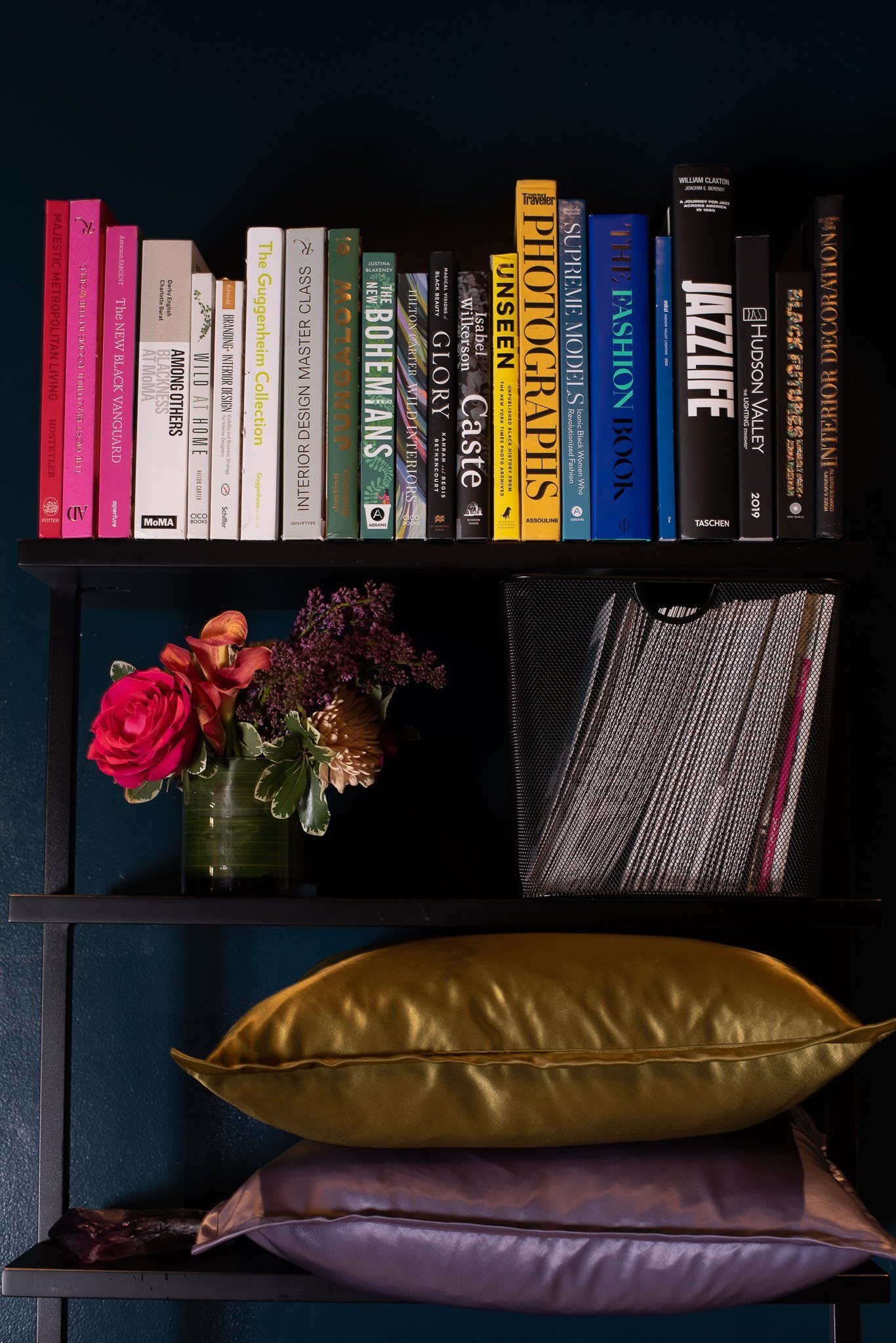 A Floral and Spice arrangement nestled among beloved books and velvet pillows