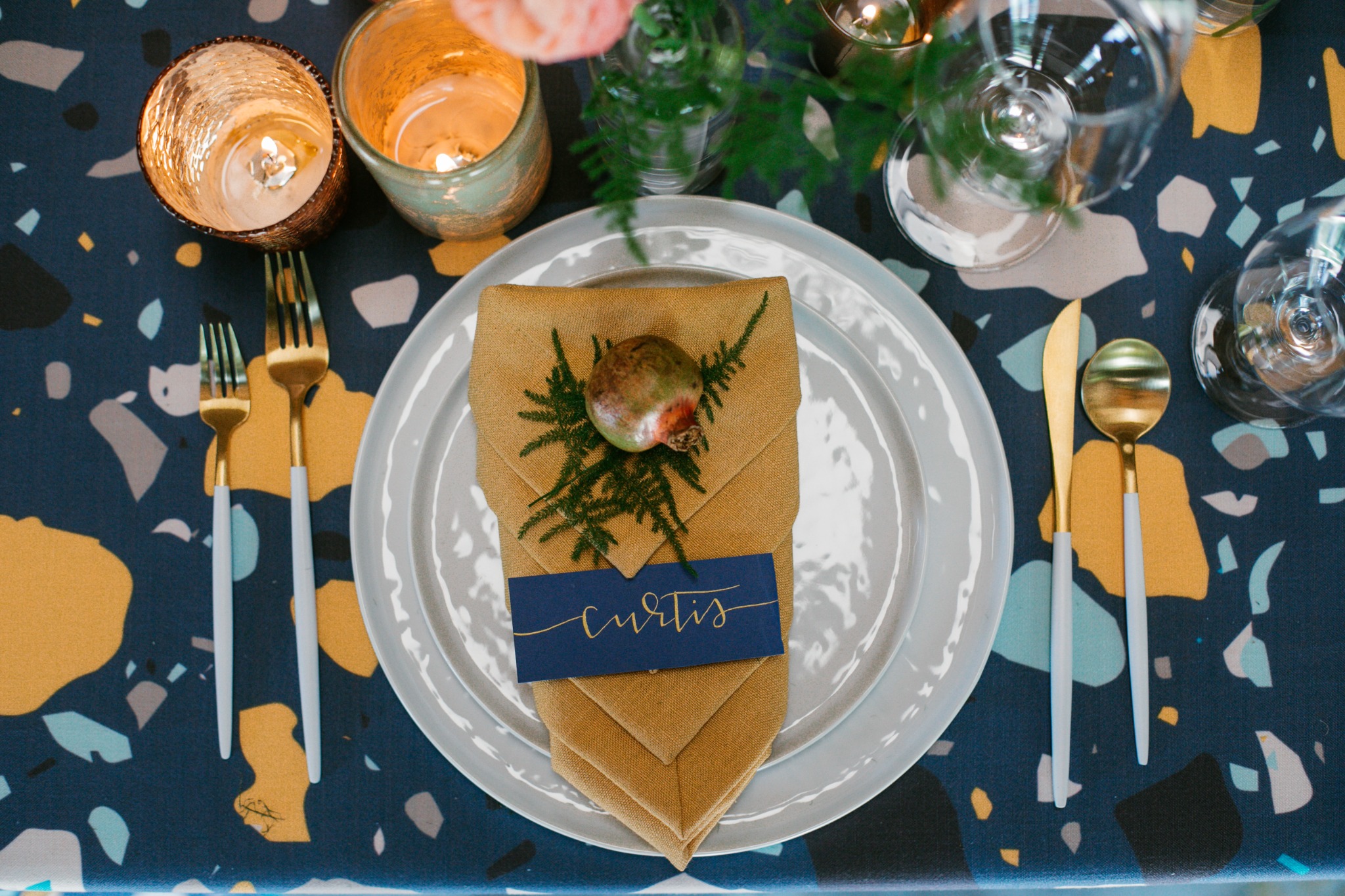 A richly layered Floral and Spice table with flowers, fruit, and candlelight